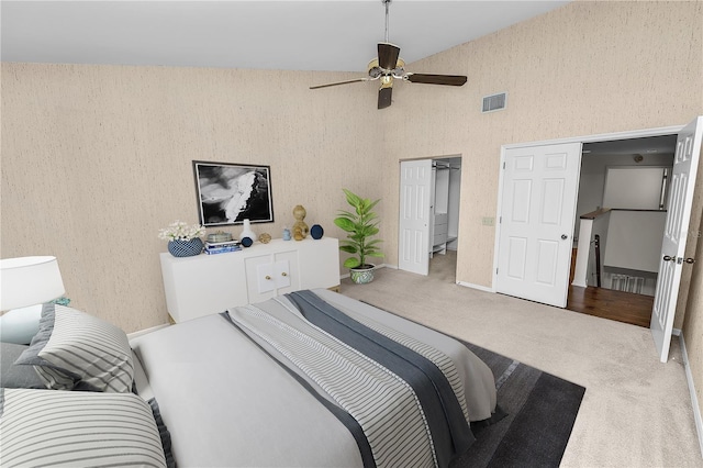 bedroom featuring a towering ceiling, carpet floors, and ceiling fan