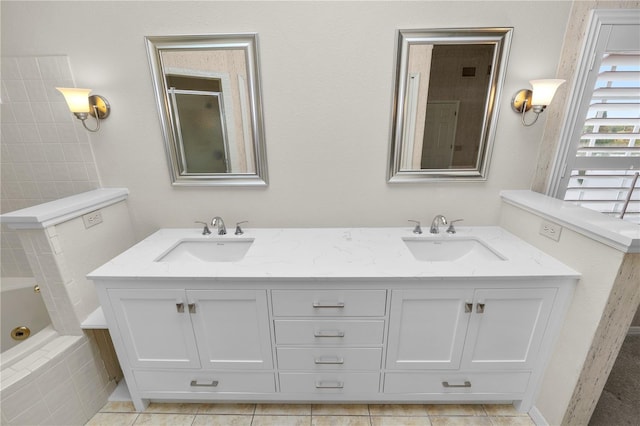 bathroom featuring vanity, tiled bath, and tile patterned floors