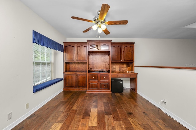 unfurnished office featuring dark hardwood / wood-style floors and ceiling fan