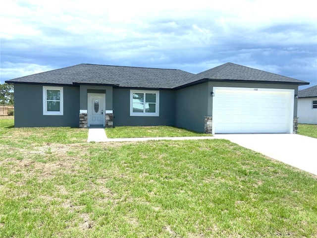 view of front of house with a garage and a front lawn