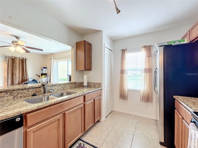 kitchen featuring a healthy amount of sunlight, light tile patterned flooring, sink, and appliances with stainless steel finishes