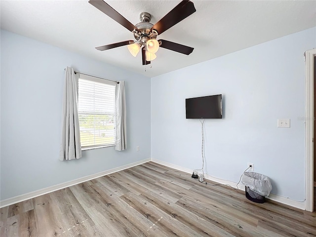 empty room featuring ceiling fan and light hardwood / wood-style flooring