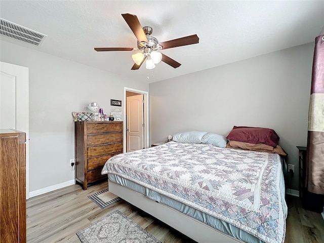 bedroom with ceiling fan and light hardwood / wood-style flooring