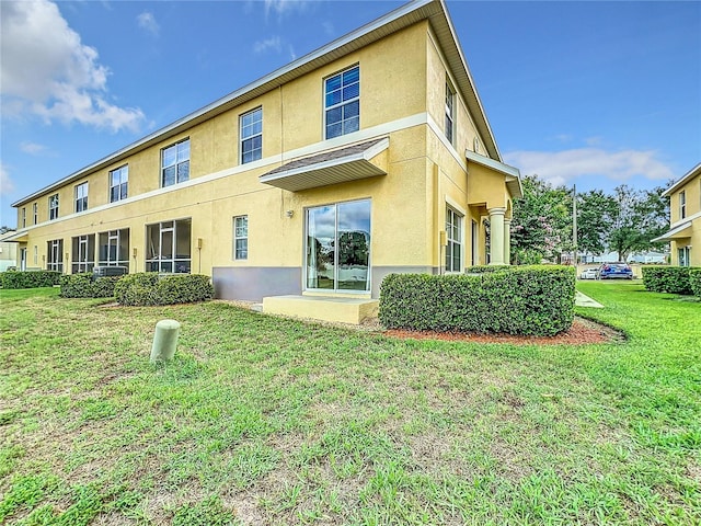 rear view of property with a yard