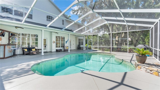 view of pool featuring a lanai, ceiling fan, and a patio area