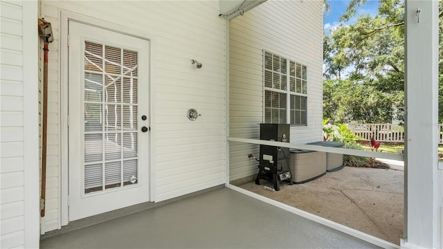 view of exterior entry featuring a patio