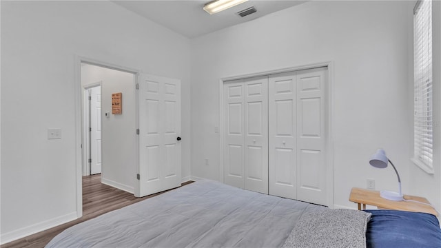 bedroom with a closet and hardwood / wood-style floors