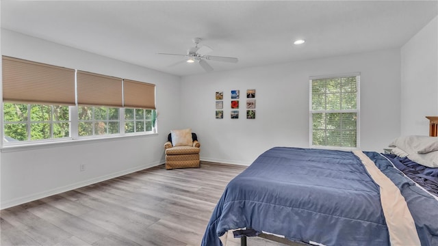 bedroom featuring ceiling fan and light hardwood / wood-style flooring