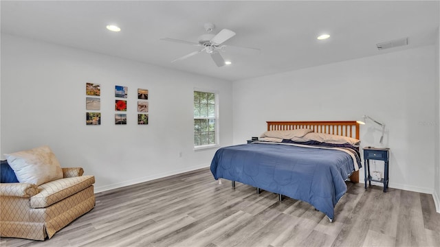 bedroom with light hardwood / wood-style flooring and ceiling fan