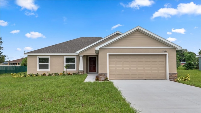 view of front of home featuring a garage and a front lawn