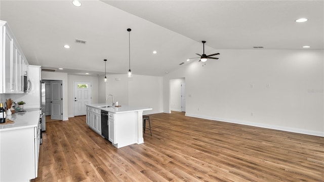 kitchen featuring dishwasher, a kitchen island with sink, ceiling fan, decorative light fixtures, and white cabinetry