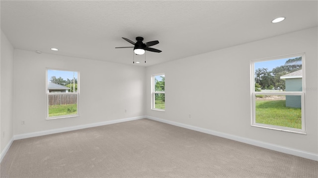 carpeted empty room with ceiling fan