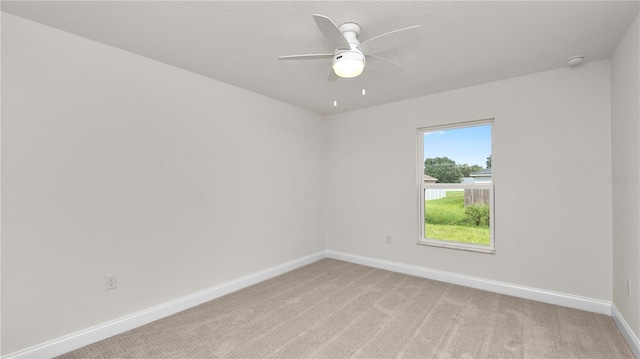 empty room featuring light carpet and ceiling fan