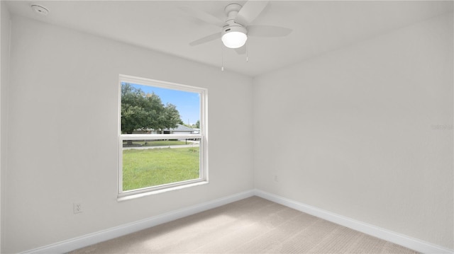 unfurnished room with ceiling fan and light colored carpet