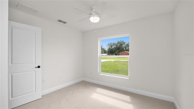 unfurnished room with ceiling fan and light colored carpet