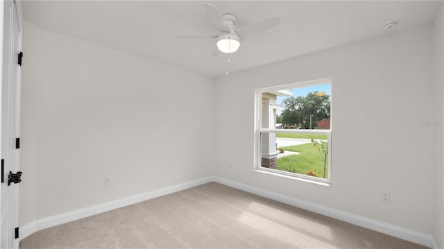 carpeted empty room featuring ceiling fan