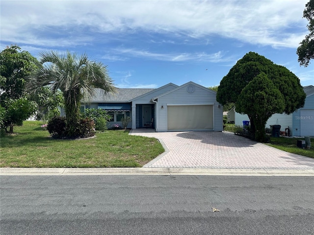 view of front facade featuring decorative driveway, an attached garage, and a front yard