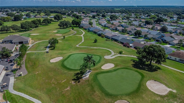 drone / aerial view with view of golf course and a residential view