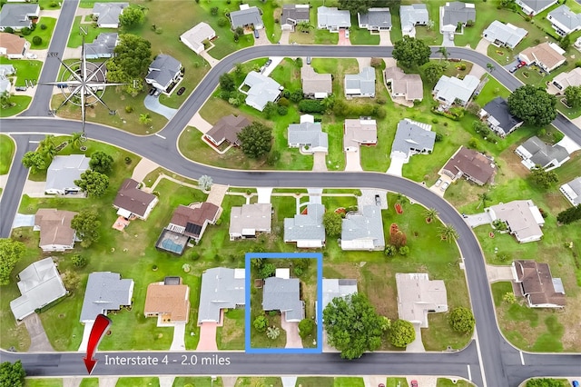 birds eye view of property with a residential view