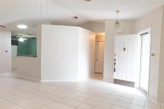 entrance foyer featuring light tile patterned floors, a ceiling fan, visible vents, vaulted ceiling, and baseboards