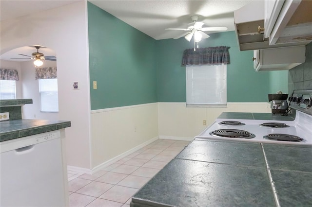 kitchen featuring white appliances, a ceiling fan, extractor fan, white cabinetry, and light tile patterned flooring