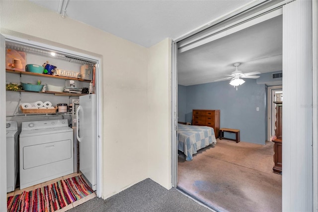 bedroom featuring visible vents, freestanding refrigerator, ceiling fan, separate washer and dryer, and carpet