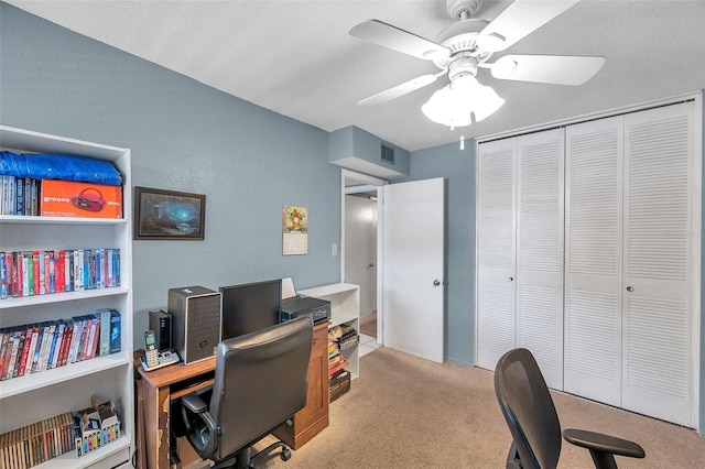 carpeted home office featuring ceiling fan and visible vents