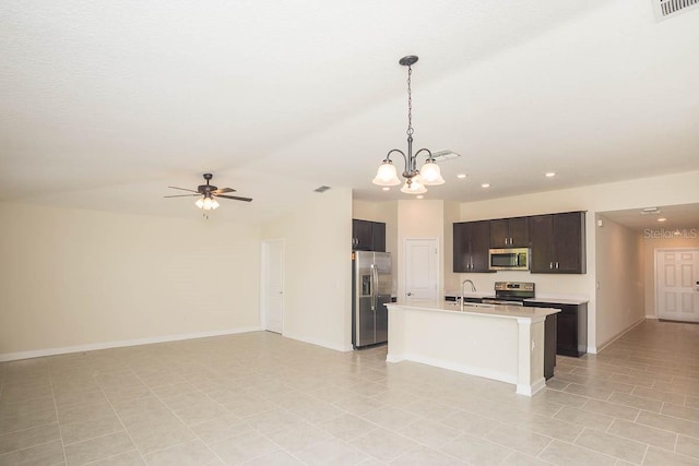 kitchen featuring dark brown cabinets, ceiling fan with notable chandelier, stainless steel appliances, sink, and pendant lighting