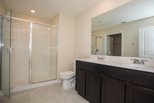 bathroom with tile patterned flooring, a shower with door, vanity, and toilet