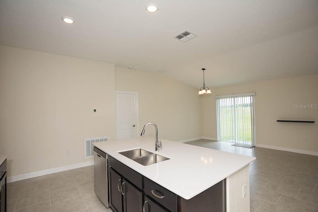 kitchen featuring sink, a center island with sink, an inviting chandelier, dishwasher, and hanging light fixtures