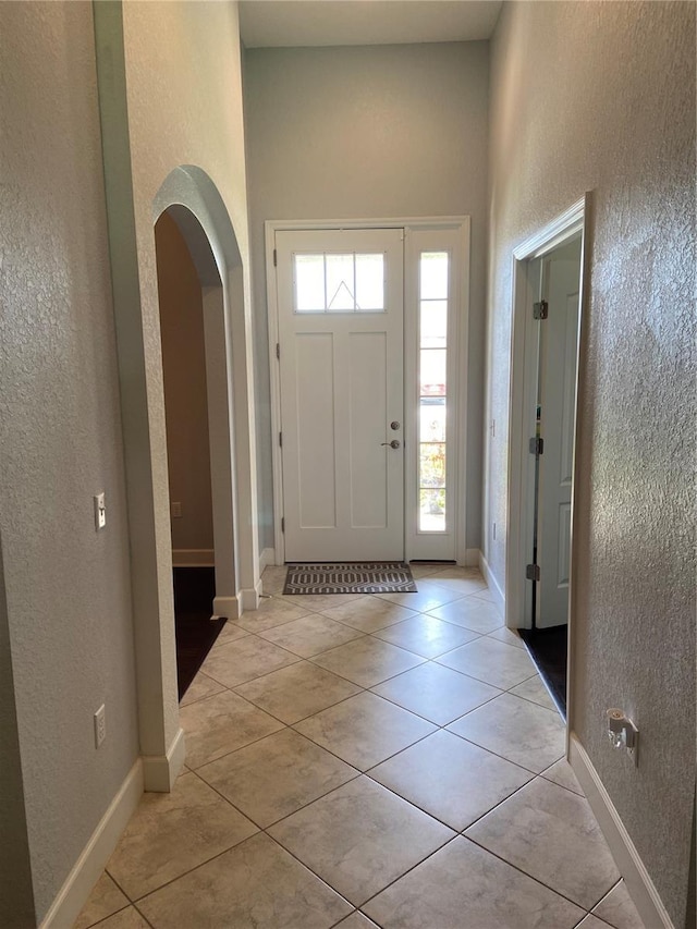 foyer featuring light tile patterned flooring