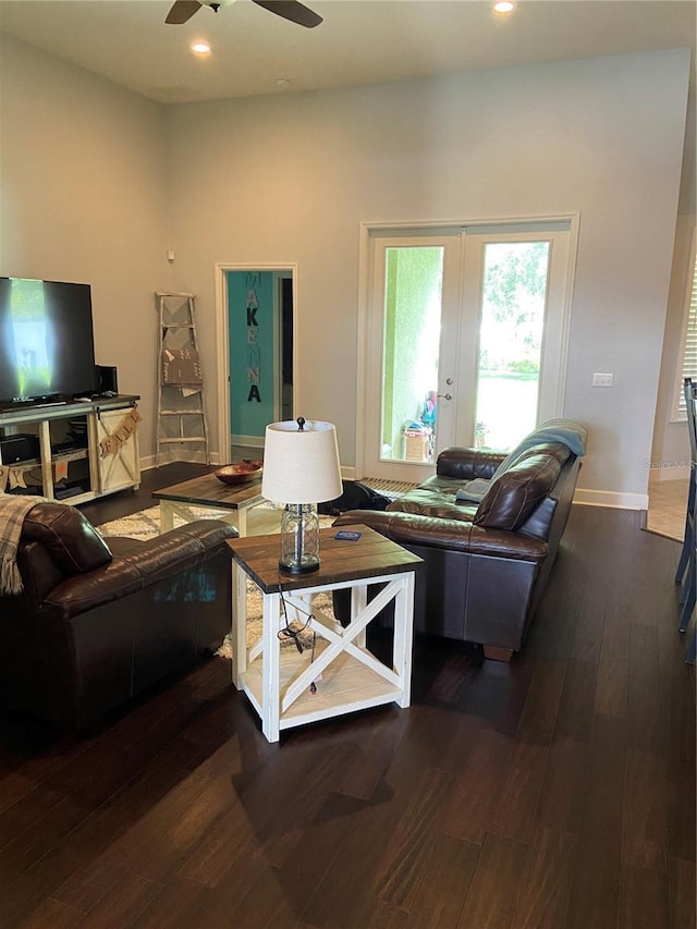 living room featuring ceiling fan, dark hardwood / wood-style flooring, and french doors