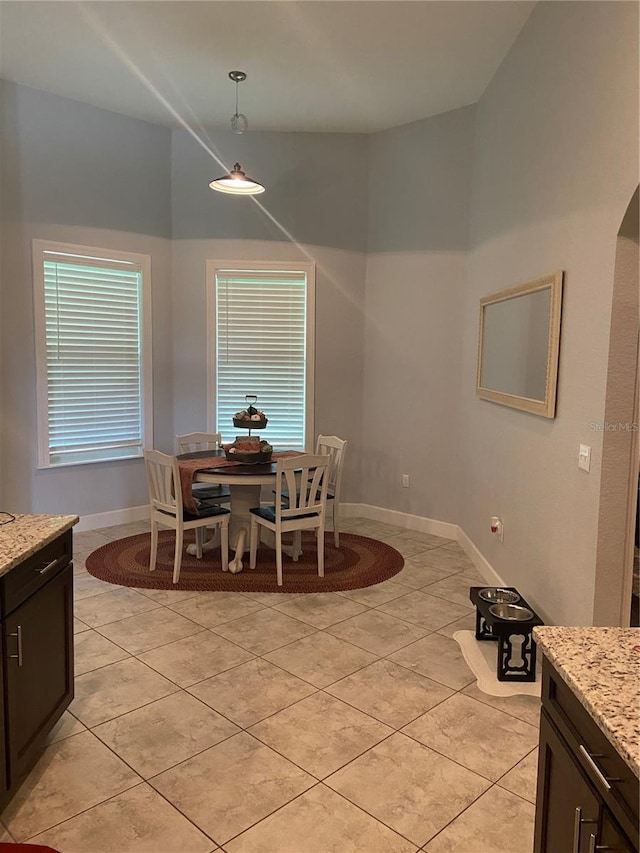 dining space featuring light tile patterned floors