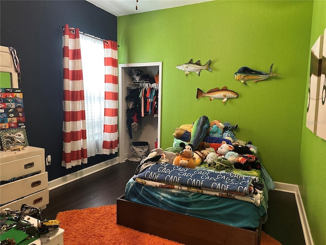 2875 Creeks Crossing Blvd, Lakeland, FL 33810 - bedroom featuring a walk in closet, a closet, wood finished floors, and baseboards