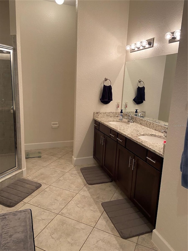 2875 Creeks Crossing Blvd, Lakeland, FL 33810 - bathroom with a stall shower, baseboards, double vanity, and a sink
