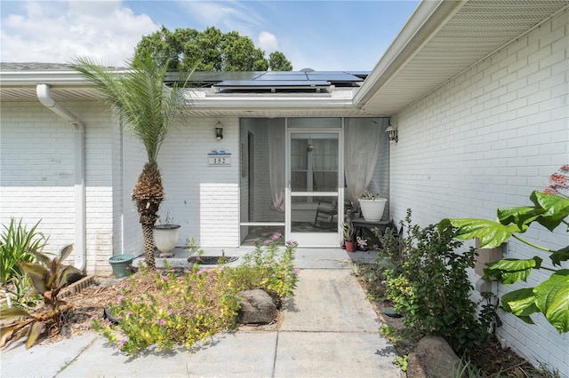 doorway to property with solar panels