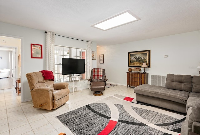 tiled living room featuring a textured ceiling