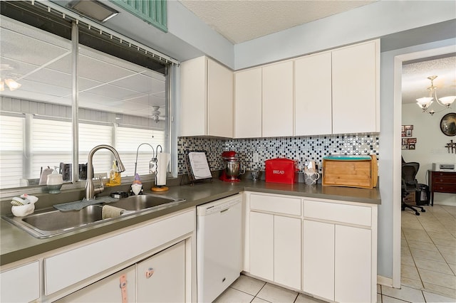 kitchen with white dishwasher, decorative backsplash, white cabinetry, and light tile patterned floors