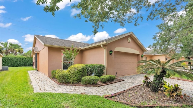 view of front of property featuring a garage and a front lawn