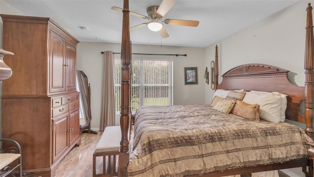 bedroom featuring ceiling fan and a textured ceiling