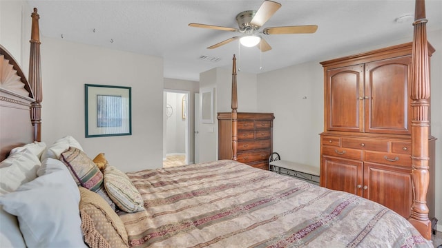 bedroom featuring ceiling fan and a textured ceiling