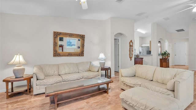 tiled living room with ceiling fan