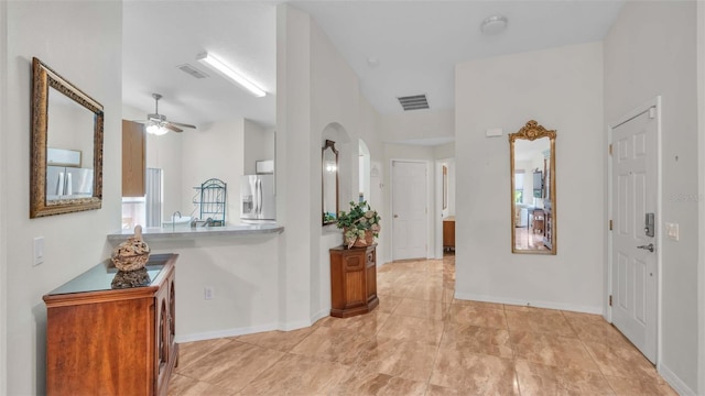 foyer with ceiling fan and lofted ceiling