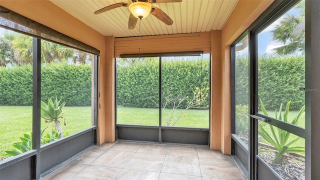 unfurnished sunroom featuring ceiling fan and wood ceiling