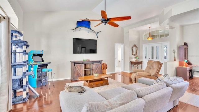 living room featuring ceiling fan, wood-type flooring, and lofted ceiling