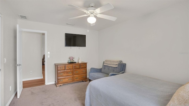 bedroom with light carpet and ceiling fan