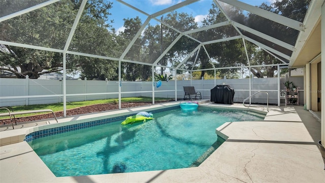 view of swimming pool with a lanai and a patio