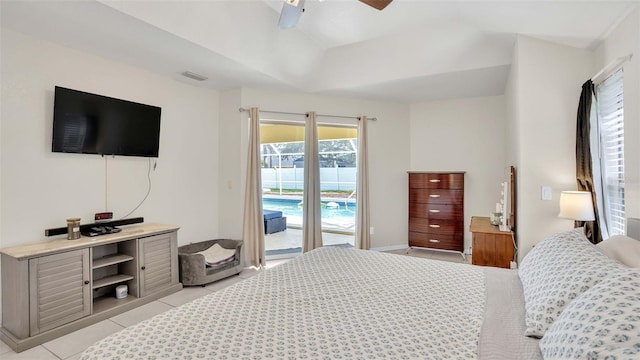 tiled bedroom featuring access to exterior, ceiling fan, and a tray ceiling