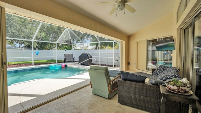 view of swimming pool featuring a lanai, ceiling fan, and a patio area