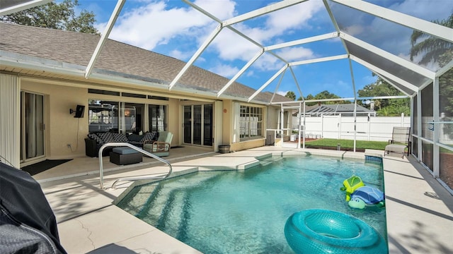 view of swimming pool featuring an outdoor living space, a lanai, and a patio